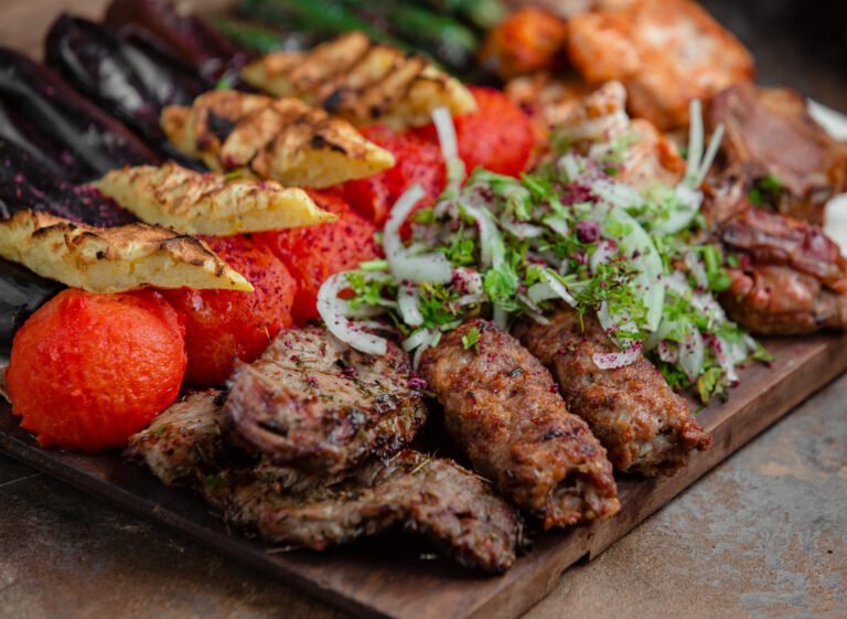 BBQ foods place on wooden cutting board.